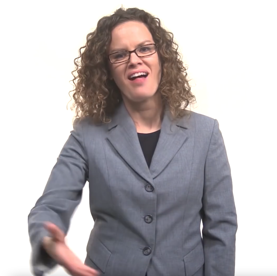 A woman in a gray blazer signing toward the viewer in American Sign Language against a light background, in a still from Finding Your Path to Employment with Ticket to Work in American Sign Language