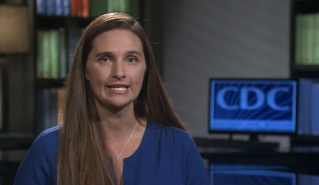 A CDC public health expert in a blue top speaking in a studio with bookshelves and a screen showing the CDC logo behind her, in a still from A National Profile of ADHD Diagnosis and Treatment among U.S. Children Aged 2-5 Years