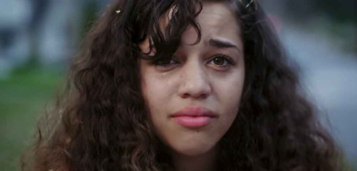 A young girl looking emotional in a still from Be Someone’s Hero