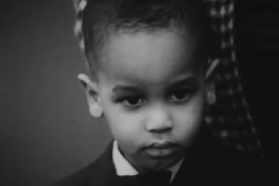 A young boy in formal clothing in a black-and-white still from Robin, Peter, and Darryl Three to the Hospital