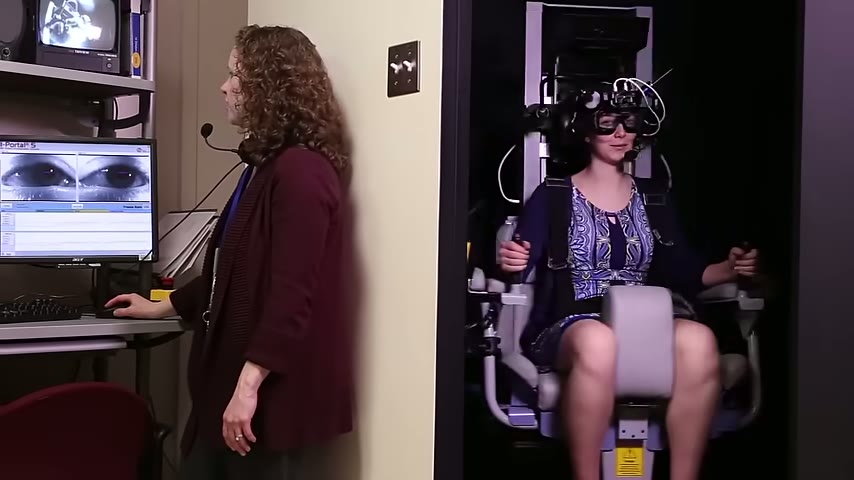 An NIH research audiologist testing a patient's balance at the NIH Clinical Center