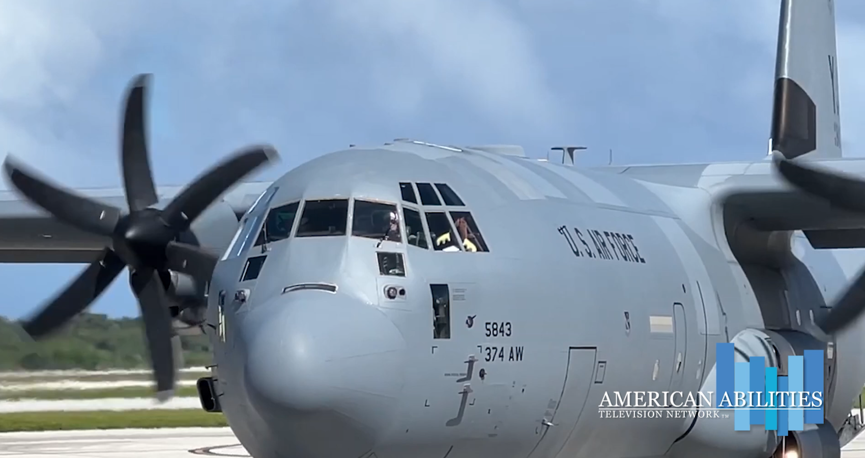 A U.S. Air Force C-130 Hercules taxiing with its propellers turning, in a still from the Operation Christmas Drop segment
