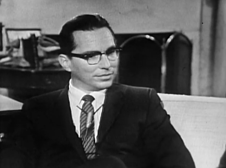 CBS News correspondent George Herman listening during the 1962 After Two Years interview, in a public-domain still from the original broadcast